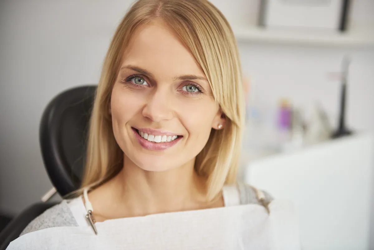 Smiling woman seated in a dental chair